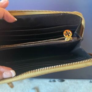 Gold Tory Burch Long wallet leather has a little wear on the corners